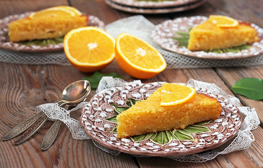 Polenta and lemon butter cake on a vintage plates on a wooden table. Selective focus