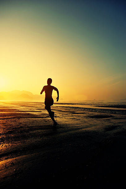 istock young woman running on sunrise beach 465874028