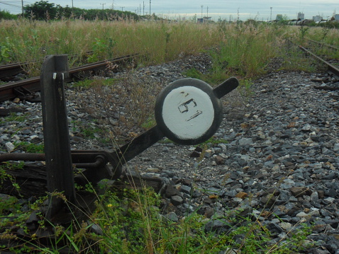 High metal pole next to the railway lines