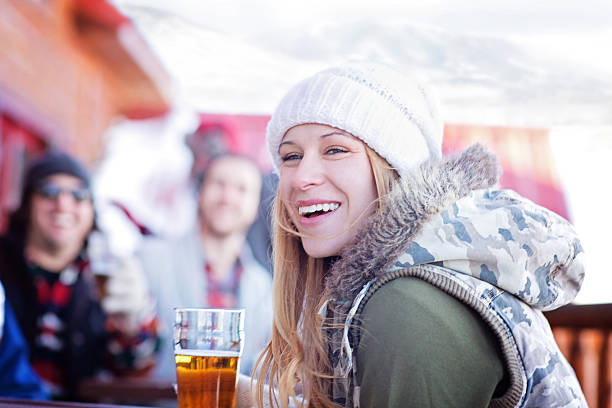 Friends Having Good Times After Skiing A group of friends having beer after skiing. apres ski party winter cabin stock pictures, royalty-free photos & images