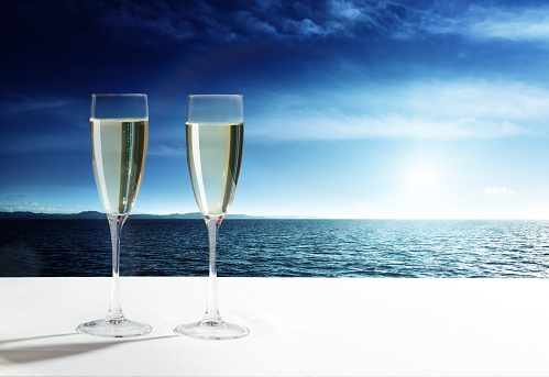 Glasses of champagne on a white background
