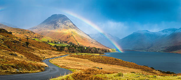 Lake District rainbow over Wast Water Western Fells panorama Cumbria Colourful rainbow soaring over the blue shore of Wast Water and Yewbarrow overlooed by the snowy peaks of Great Gable and Scafell in this picturesque panoramic vista of the Lake District National Park, Cumbria, UK. ProPhoto RGB profile for maximum color fidelity and gamut. english lake district photos stock pictures, royalty-free photos & images