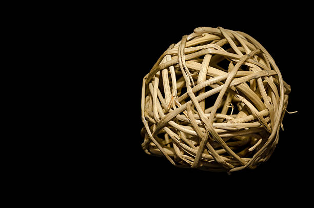 ball of woven straw isolated on a black background