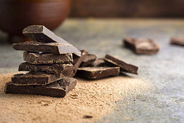 istock pieces of dark chocolate stacked on grunge background 465884812