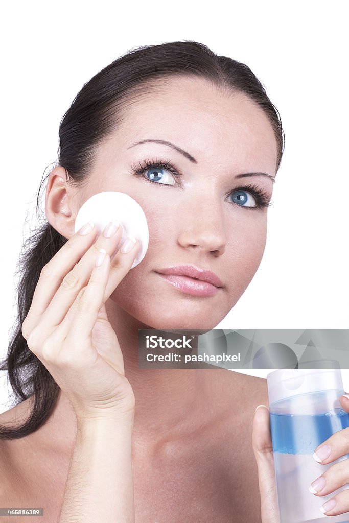 Remove make-up Woman cleaning her face by cotton disc, closed-up portrait Adult Stock Photo