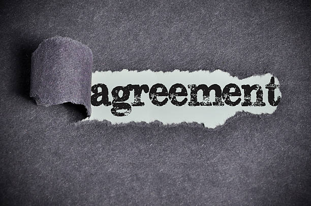 istock agreement word under torn black sugar paper 465890238