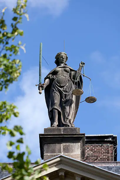 Old statue of Lady Justice on the Gravensteen in Leiden, Holland