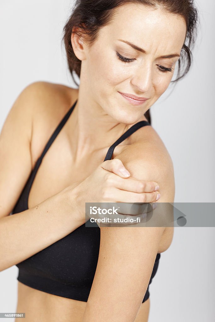 Woman in fitness Young woman with muscle pain after fitness workout. Adult Stock Photo