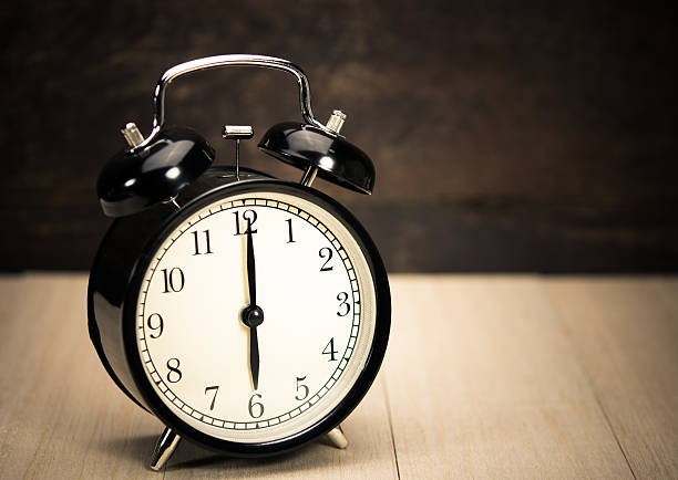 istock Vintage Alarm clock on wood wall table  background. 465893676