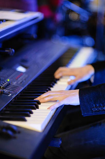 musician playing keyboard hands of musician playing keyboard in concert with shallow depth of field rocker nails stock pictures, royalty-free photos & images
