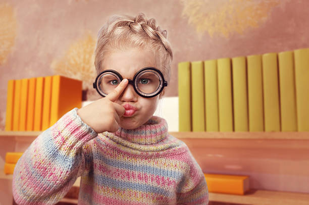 istock Little girl in glasses makes faces 465894728