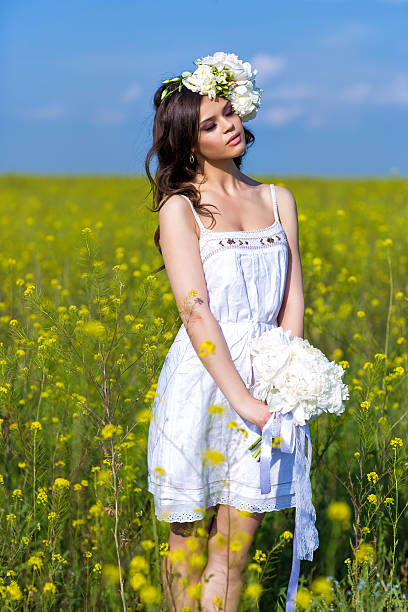 istock Young beautiful woman in a summer field 465901655