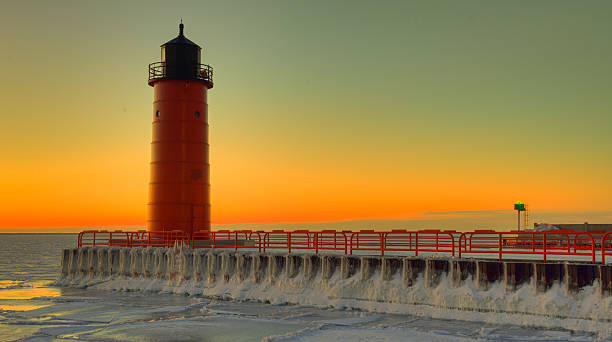 istock Red Lighthouse in winter at sunrise 465901728