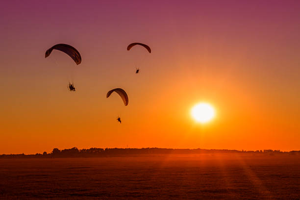 paragliding into the sunset paragliding into the sunset-Hungaryparagliding into the sunset-Hungarysummer paragliding-Hungaryparagliding into the sunset-Hungary para ascending stock pictures, royalty-free photos & images