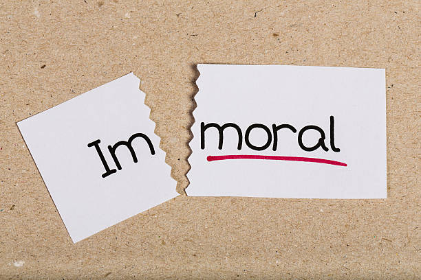 Two pieces of white paper with the word immoral turned into moral