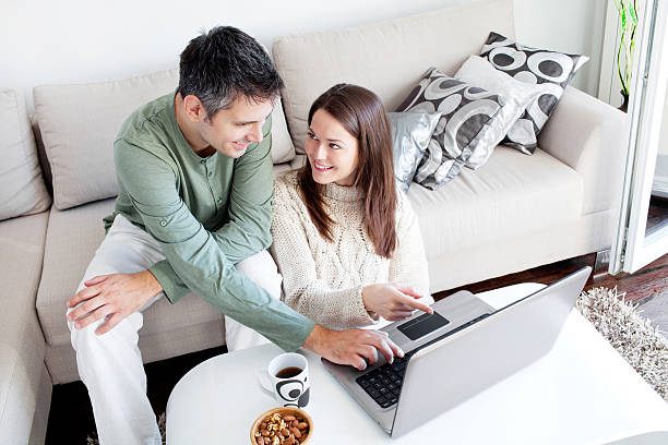 istock A couple using a laptop in a modern living room 465906479