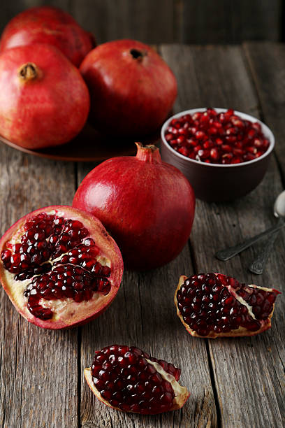 istock Delicious pomegranate fruit on grey wooden background 465906652