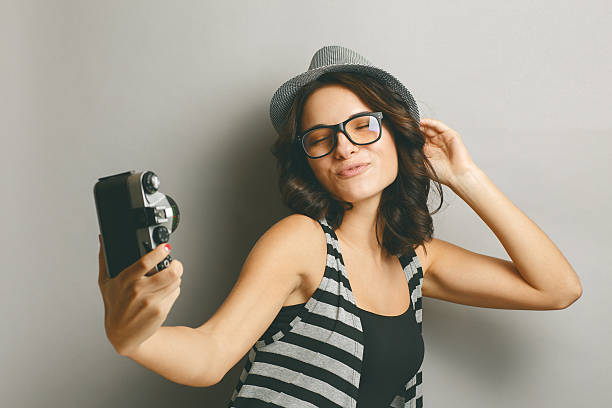 istock Beautiful girl in a hat with camera. 465907830