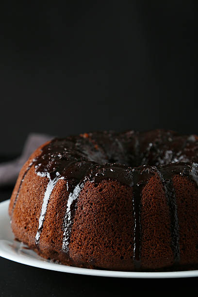 istock Chocolate bundt cake on plate on black background 465910570