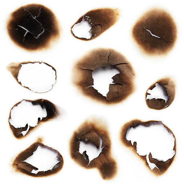 Burnt holes of paper stock photo