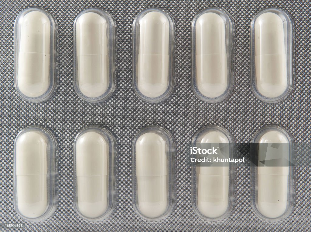 Medicine aluminum blister pack White capsule in blister pack background Backgrounds Stock Photo