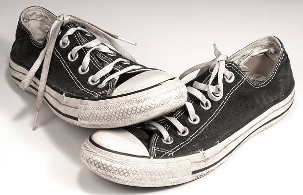istock pair of black canvas sneakers on white background 465917996