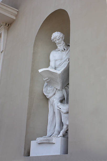 istock stone sculpture of a man with a book 465918725