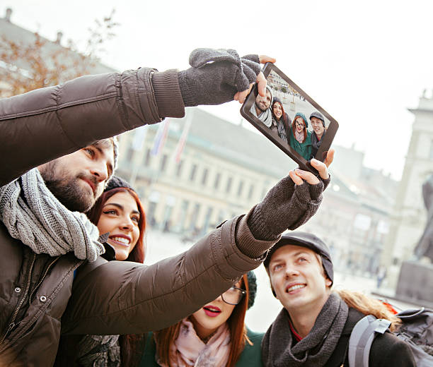 istock Group Of Tourists Taking Selfie 465919562