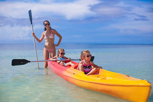istock Young mother and two her little daughters kayaking 465920052