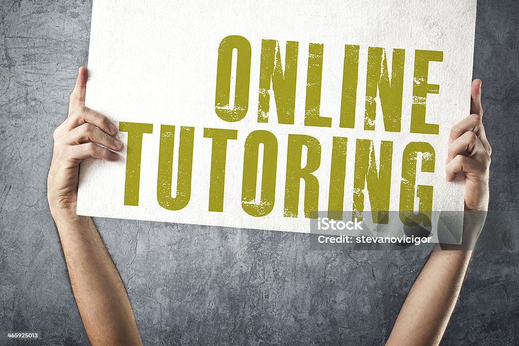 Man holding banner with ONLINE TUTORING title Man holding banner with ONLINE TUTORING title, conceptual image Advertisement Stock Photo