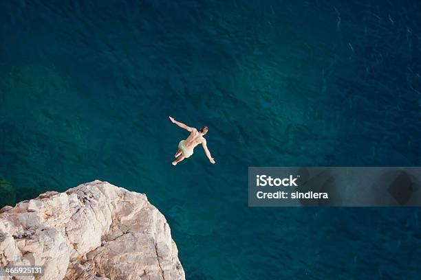 Joven Saltar Del Acantilado En El Mar Foto de stock y más banco de imágenes de Saltar - Actividad física - Saltar - Actividad física, Agua, Coraje