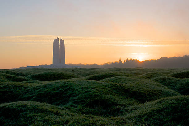 Canadian War Memorial, Vimy Ridge, France, at dawn Dawn breaks behind the Canadian War Memorial, Vimy Ridge France. The remains of shell holes can be seen dotting the landscape around the memorial. vimy memorial stock pictures, royalty-free photos & images