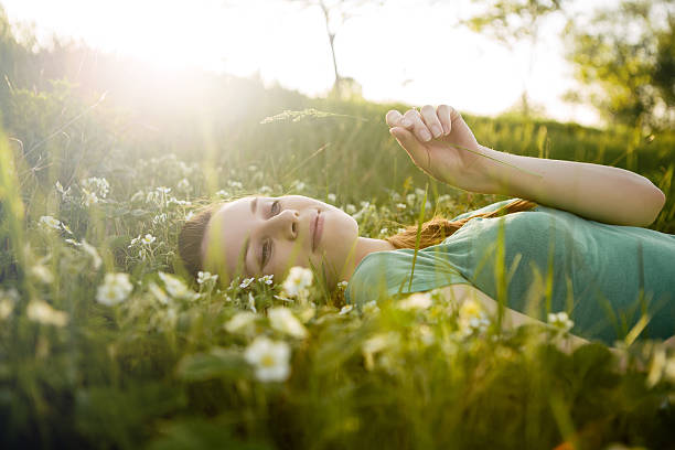 istock Young girl lying on the grass 465929291