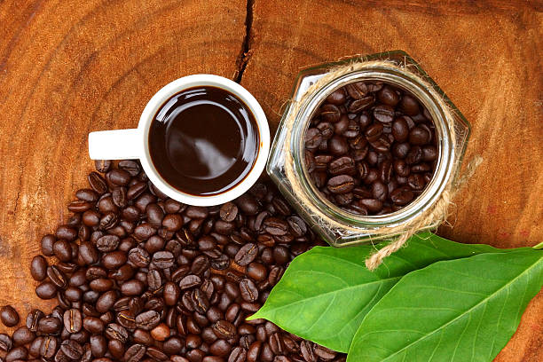 istock Roasted coffee beans on wood and black coffee. 465931429