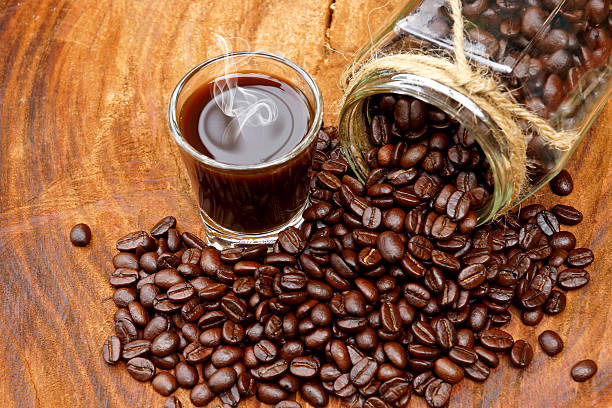 istock Roasted coffee beans on wood and black coffee. 465932415