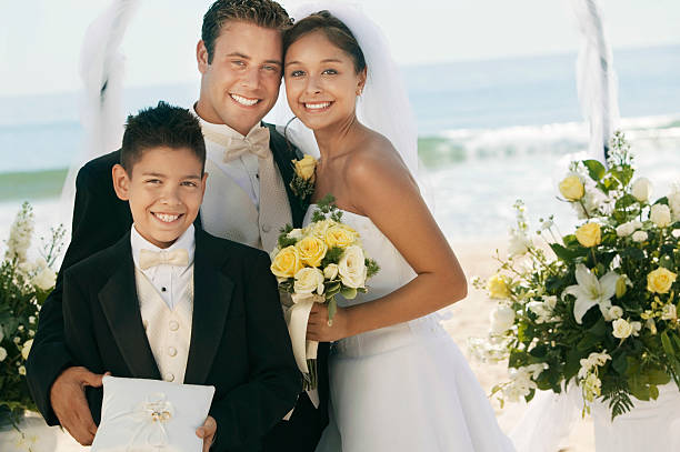 istock Couple With Boy Holding Rings At Beach 465933563