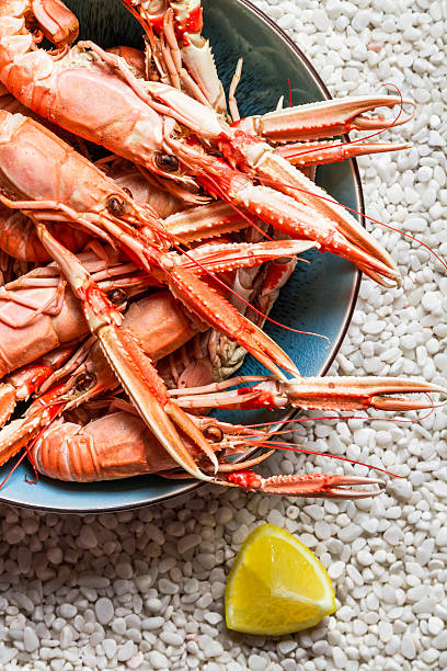 istock Scampi served with lemon on the beach 465936957
