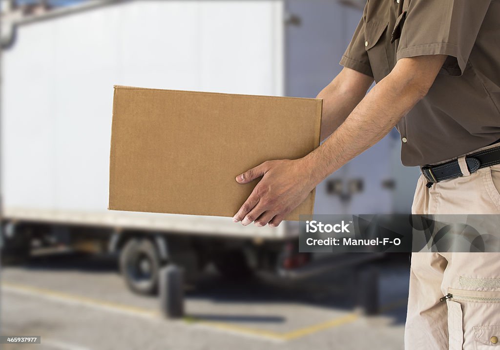 handing out cardboard box man handing out cardboard box with a truck Box - Container Stock Photo