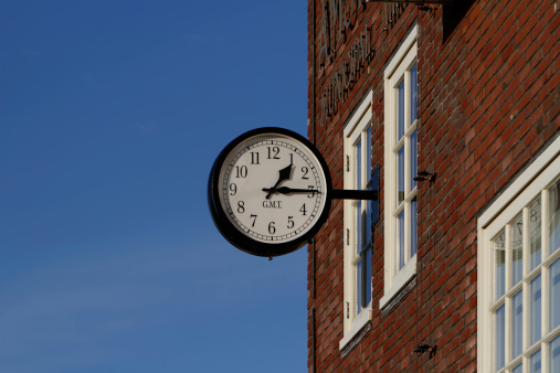 Classical Style Station Clock on a Red Brick Wall. The Clock has it's own Clipping Path. 