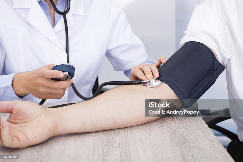Doctor's Hand Checking Blood Pressure Close-up Of Female Doctor's Hand Checking Blood Pressure Adult Stock Photo
