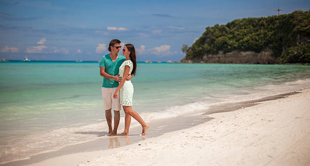 istock Young couple enjoying each other on sandy white beach 465941006