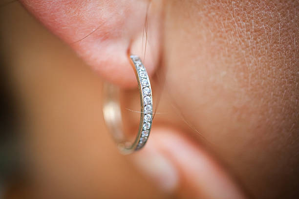 Close up image of female ear Close up image of female ear with earring diamond earring stock pictures, royalty-free photos & images