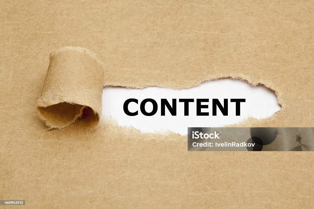 Content Torn Paper Concept The word Content appearing behind torn brown paper. Article Stock Photo