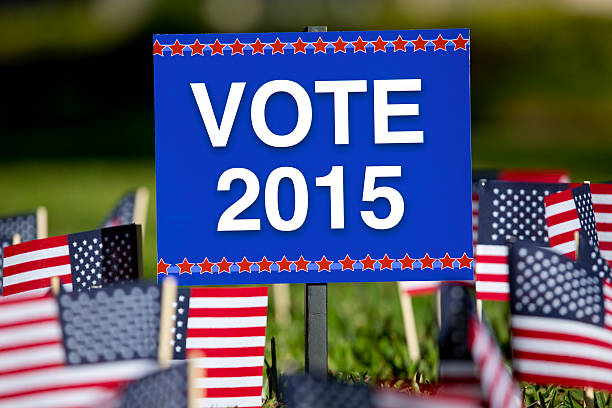 istock American Vote 2015 sign surrounded by American flags 465943980