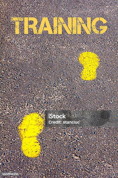 Yellow Footsteps On Sidewalk Towards Training Message Stock Photo - Download Image Now