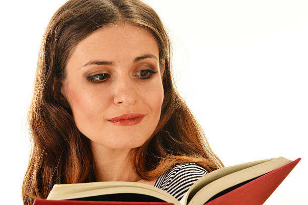 istock Young woman reading a book isolated on white 465944671