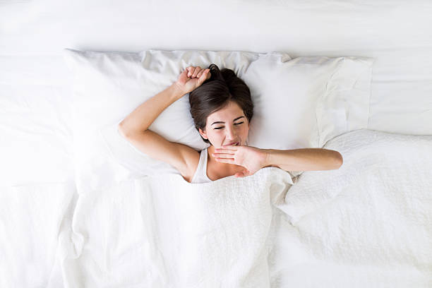 istock High angle view of woman yawning 465944808