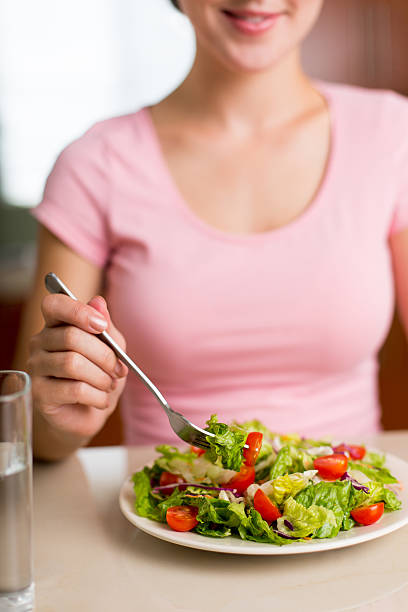 istock Woman eating vegetable salad 465944814