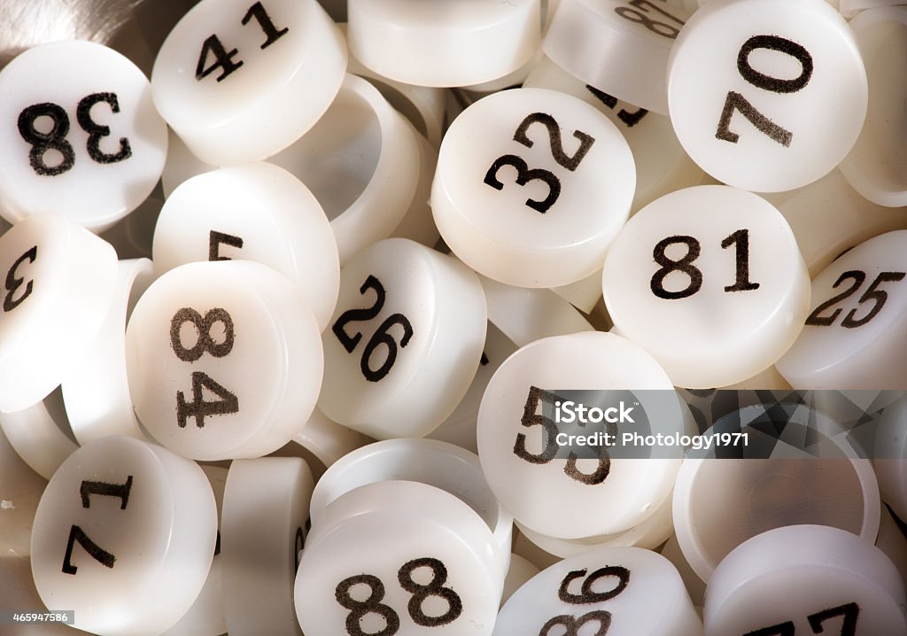 Plenty of White Plastic Bingo Game Numbers Close up Plenty of Plastic Round Bingo Game Numbers in White with Black Prints. Bingo Stock Photo