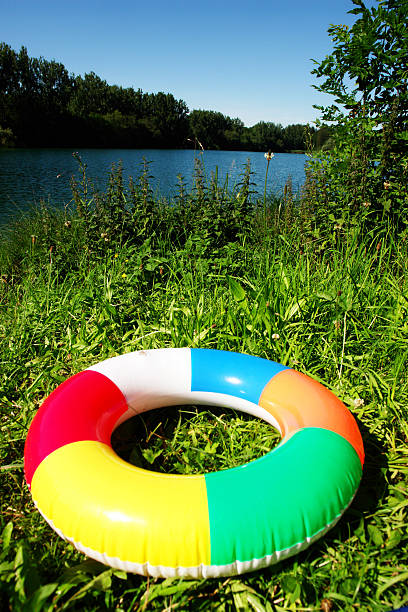 anello nuoto sul lago - inflatable ring inflatable float swimming equipment foto e immagini stock